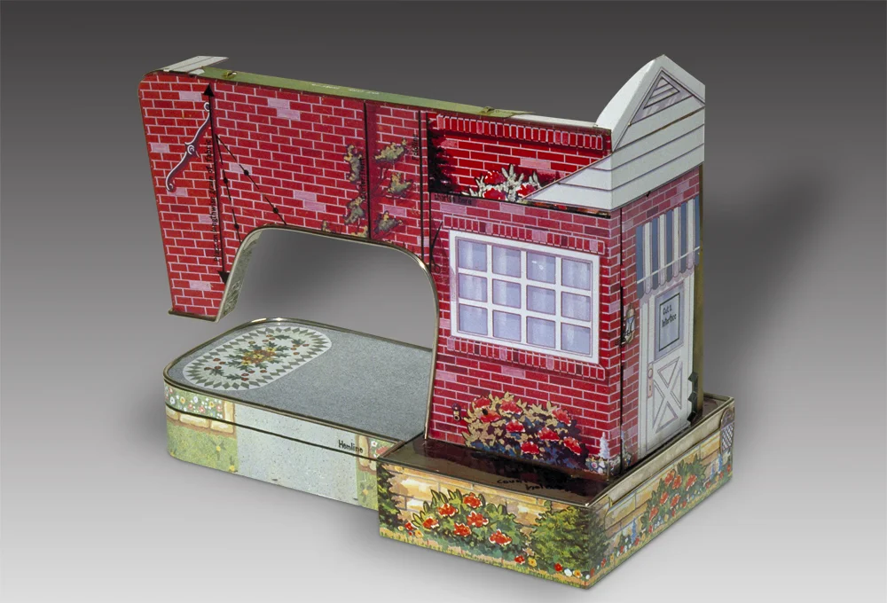 Fabrication sculpture that looks like a sewing machine and house