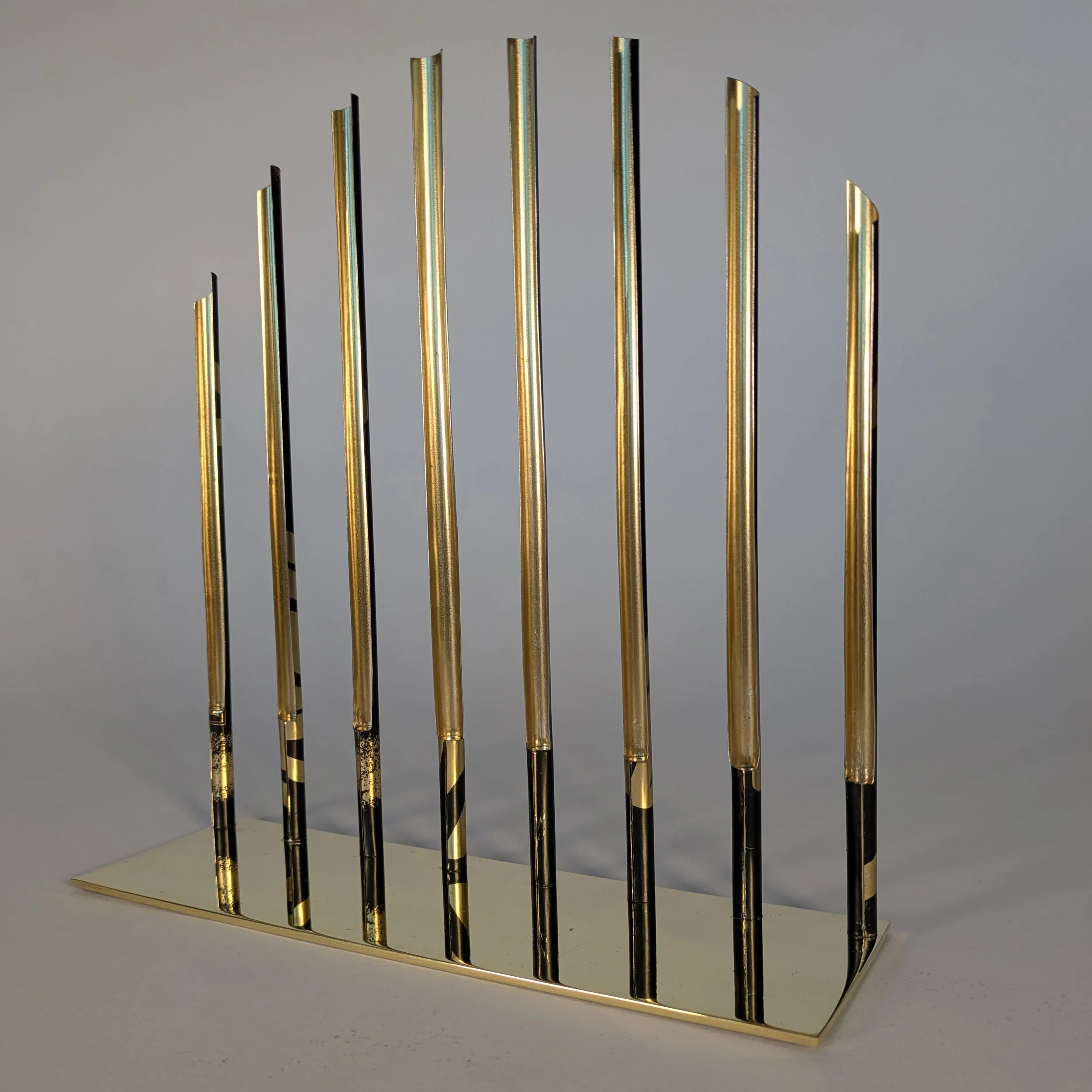 Display stand for Gold Card Visa bracelet is constructed from polished brass and recycled tin cans. This is the metallic gold side of the bars. Si