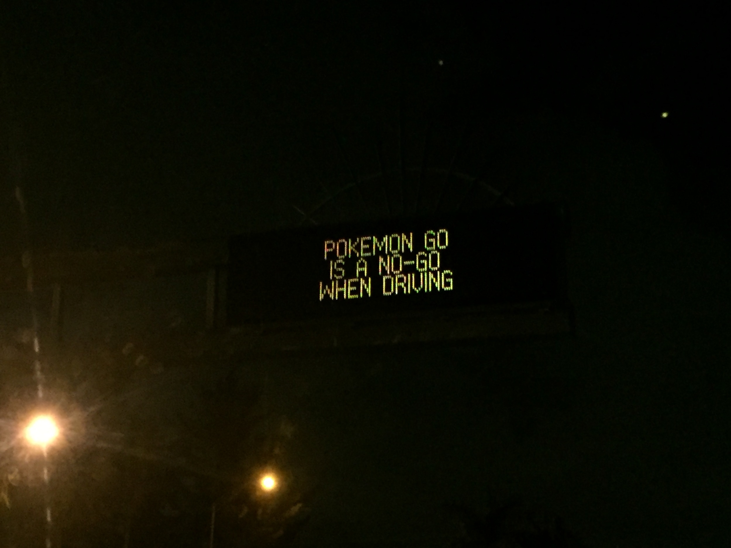 A traffic advisory sign highlights the dangers of playing Pokémon Go whilst driving.
