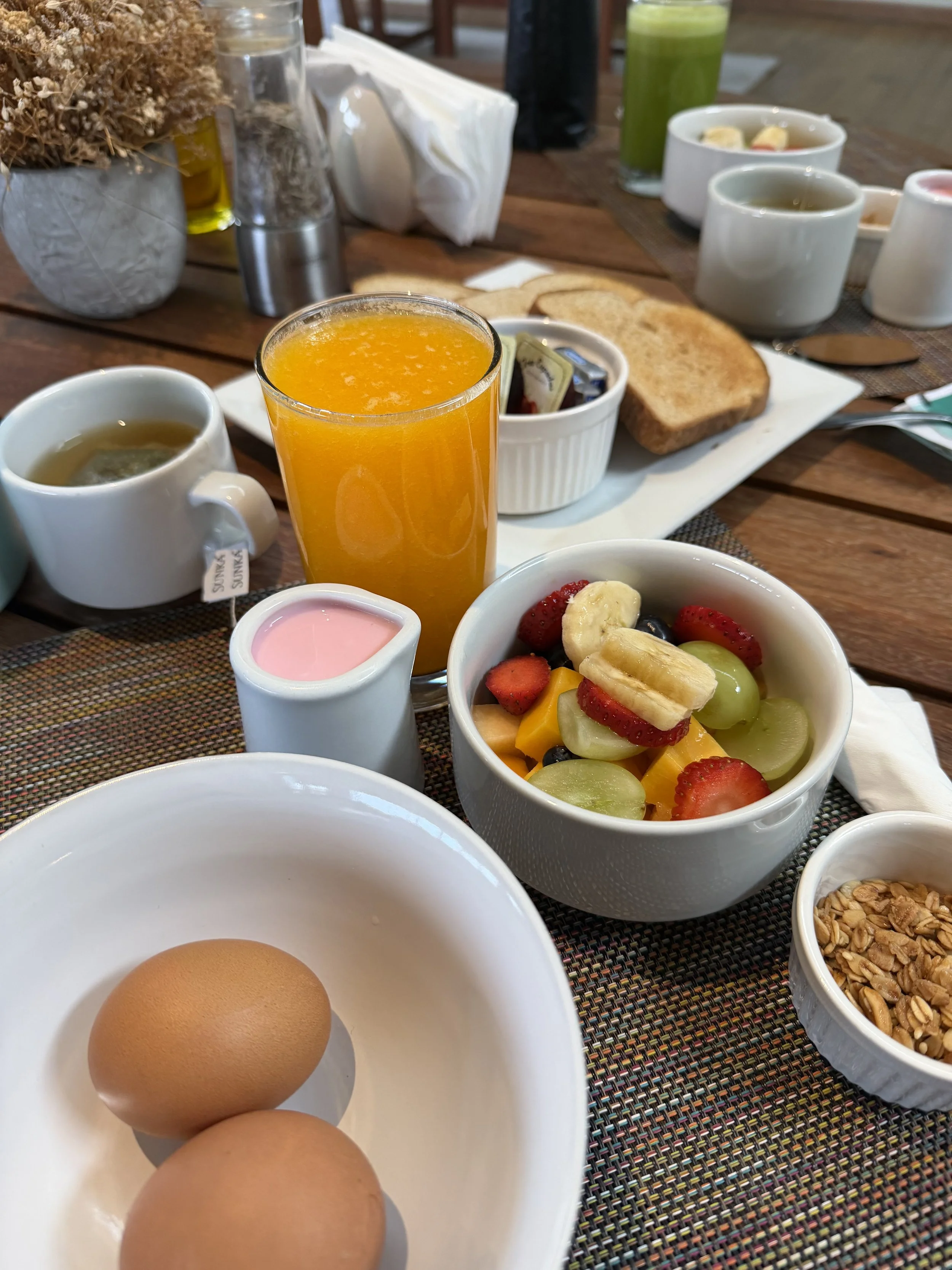 Breakfast eggs, fruit, yogurt, and granola