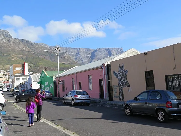The girls in Cape Town, South Africa searching for the famous Woodstock murals. Our Summer is their Winter, so we needed our coats.