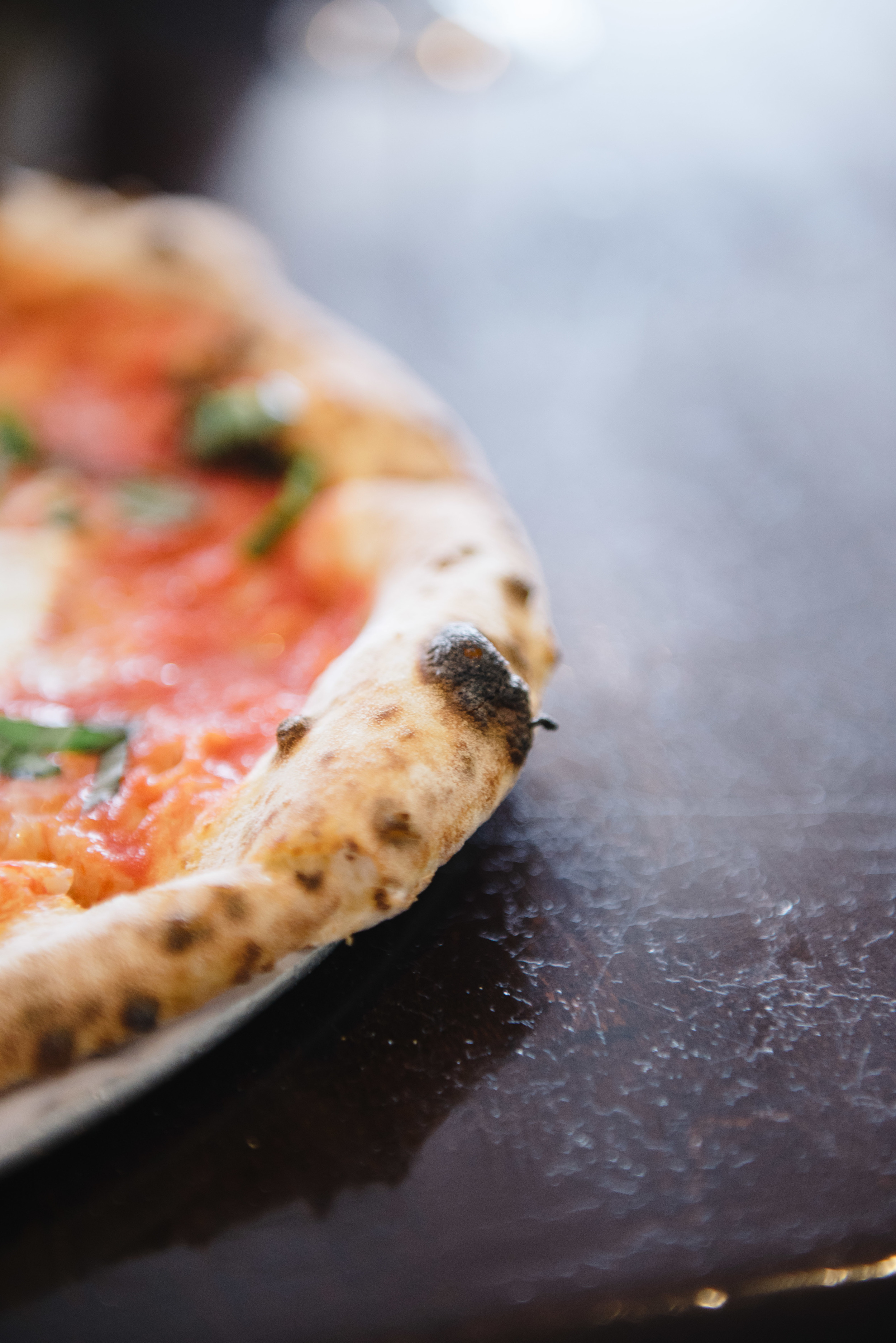 Pizarro's crusts have a Naan like quality. It isn't greasy like American style pizzas.