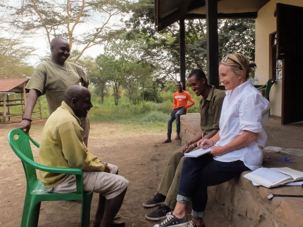 Sam and I trying to interview this old Maasai guy in the yellow sweater. She'd ask a question to the young guy to her right in English, he would translate it to Swahili for the guy in the green T-shirt, and that guy would translate it to Maasai for the old guy, then his response would come back down the line. A lot more laughing than useful interview material. 
