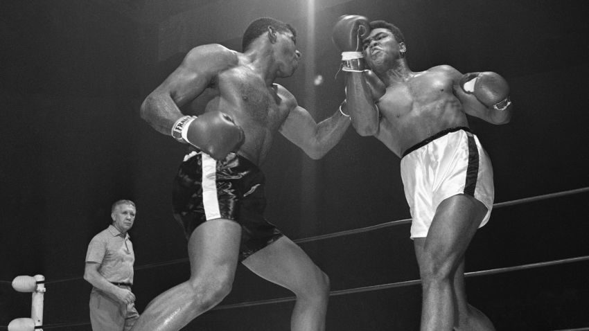 Floyd Paterson, left, delivers a left hook to the chin of Muhammad Ali during a heavyweight title fight in November 1965. –The Associated Press