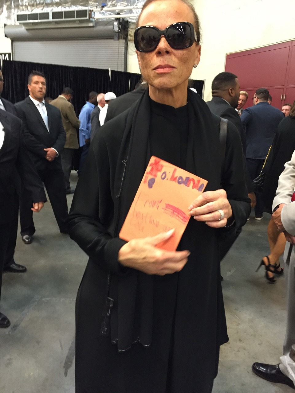 Lonnie Ali holding the card Lola made for her.