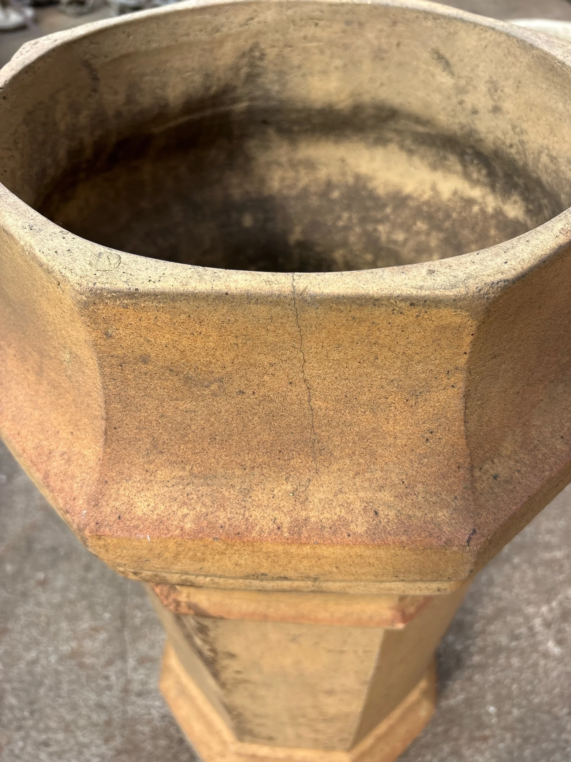 Antique terracotta chimney pot with square base and rustic aged character, ideal for planters