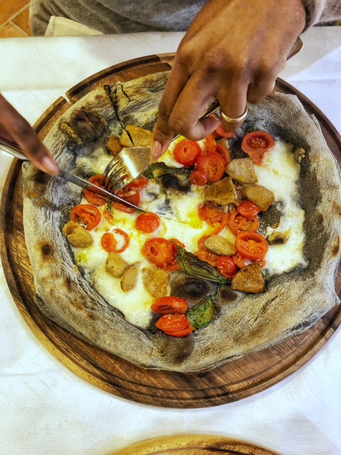 Beato Te Milano - hands cutting pizza.jpeg