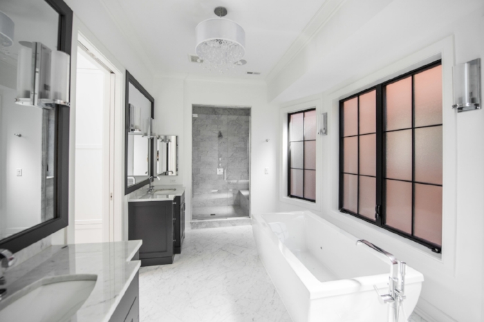 Black and white never goes out of style in this bathroom we designed for an elegant single family home.