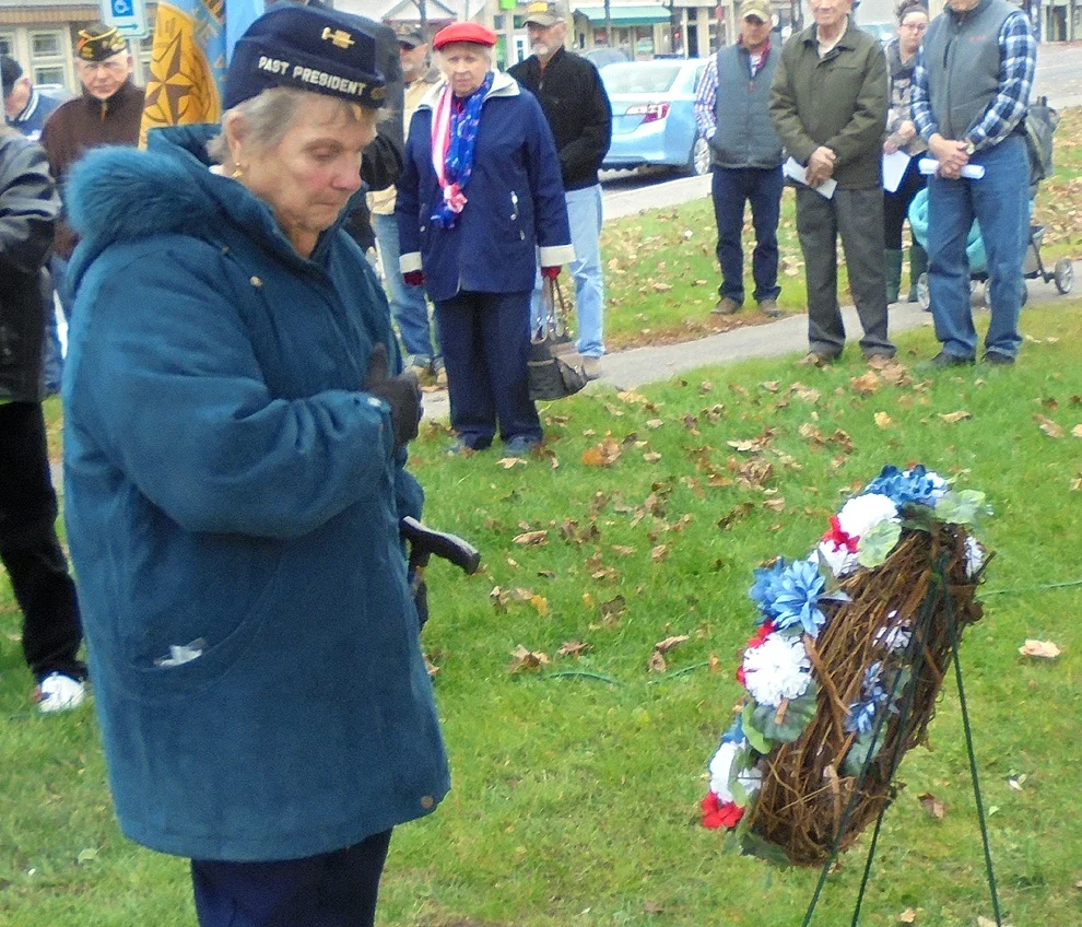 Gouverneur American Legion Ladies Auxiliary President Gloria Youngs is shown presenting flowers at the observance of Veterans Day held on Friday, November 11.