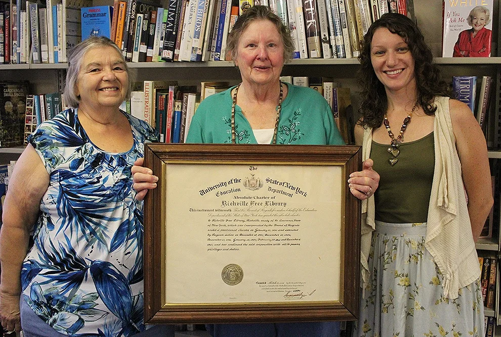 Pictured above with the charter of the Richville Free Library is (from left) Brenda Woodward, President of the Richville Library Board of Trustees, Lila Youngs, retiring Richville Library Director after 26 years of dedicated service, and Britny Harmer, incoming Richville Library Director. (Rachel Hunter photo)