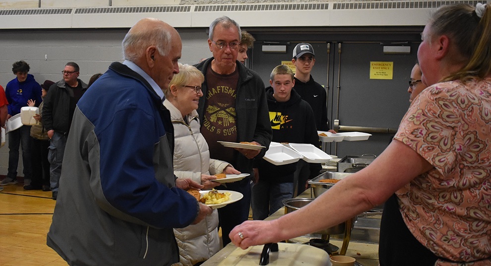   The first St. James fish fry dinner of the season drew a great number of people. A long line went through the gymnasium in anticipation of getting their delicious meal. (photo by Jessyca Cardinell)  