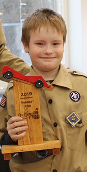   Qhuin Langille won the Raddest Rod trophy for his red pinewood derby car. Qhuin is pictured (at right) with Cubmaster Chris Gates (at left). (Rachel Hunter photo)  