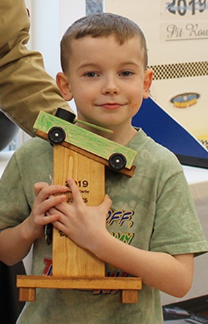   Damian Travis won the Judge’s Choice trophy for his pinewood derby tanker. Damian Travis is pictured (at right) with Cubmaster Chris Gates (at left). (Rachel Hunter photo)  