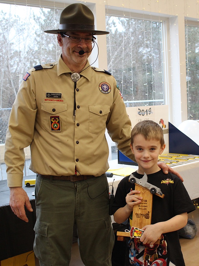   Nathan Zeller won the Slowest Roller trophy for his shark-themed pinewood derby car. Nathan Zeller is pictured (at right) with Cubmaster Chris Gates (at left). (Rachel Hunter photo)  