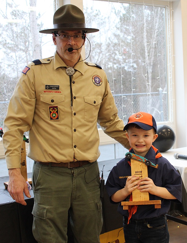   Abel Halladay won the Coolest Paint Job trophy for the bright flames that adorned his pinewood derby car. Abel Halladay is pictured (at right) with Cubmaster Chris Gates (at left). (Rachel Hunter photo)  