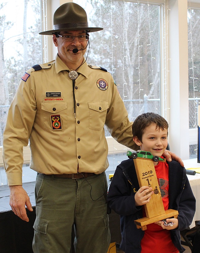   Jax Spicer won the First Place trophy for the fastest derby car. Jax Spicer is pictured (at right) with Cubmaster Chris Gates (at left). (Rachel Hunter photo)  