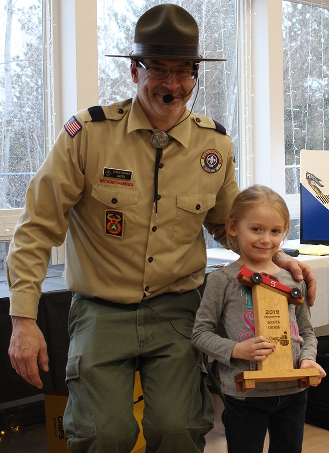   Aubree Spicer (at right) won the Scouts Choice trophy, presented by Cubmaster Chris Gates (at left). (Rachel Hunter photo)  