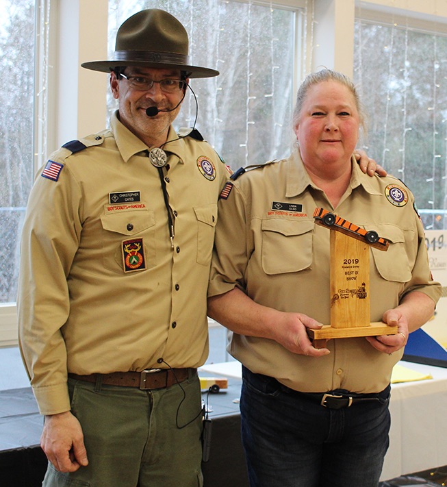   Cub Scout Pack 2035 Committee Member Linda Gilbo of Richville (at right) won the Best In Show trophy, presented by Cubmaster Chris Gates (at left). (Rachel Hunter photo)  