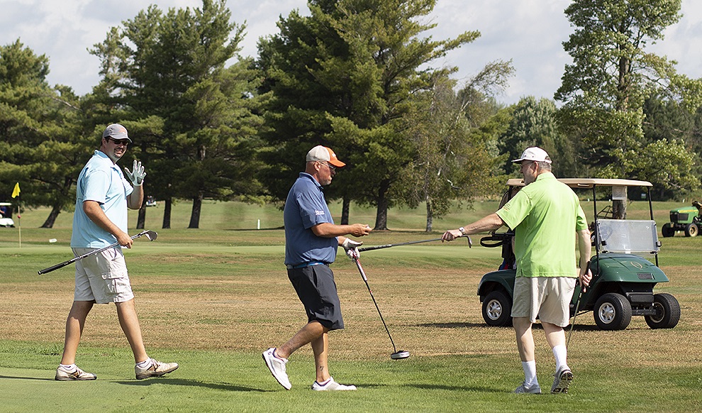   Local golfers participating in the 2019 Ryan’s Wish Golf Tournament on Saturday, August 17 give a gentle wave after they successfully sunk their ball in the first hole at Emerald Greens in Gouverneur. (Rachel Hunter photo)  