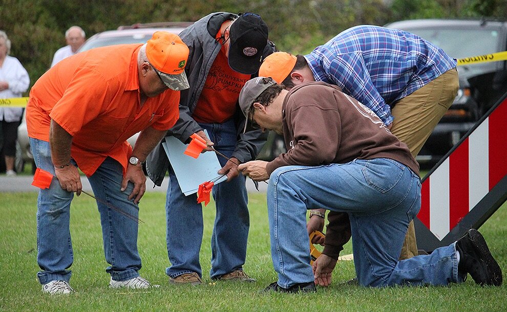   Past Fair President Lyle Hotis writes down the distance and number of a golf ball that was one of the furthest traveled after the first 2019 Gouverneur Pumpkin Festival Giant Pumpkin Drop. Also pictured, Fair Director Dave Bishop of DeKalb, Fair As