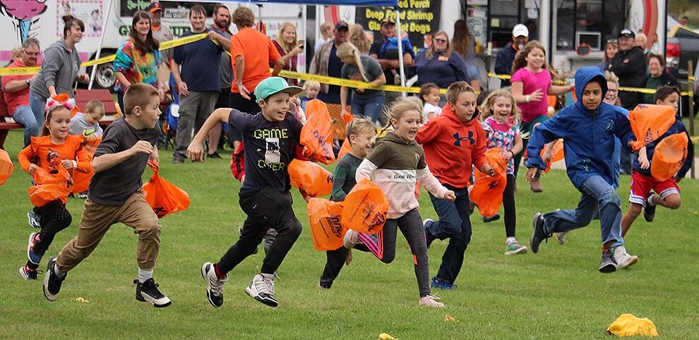   Youngsters run to collect the golf balls after the first 2019 Gouverneur Pumpkin Festival Giant Pumpkin Drop on Saturday, September 28 at the Gouverneur Fairgrounds. (Rachel Hunter photo)  