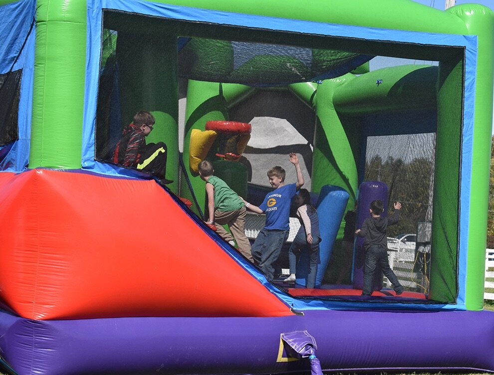   The bounce houses at the 8th Annual Gouverneur Pumpkin Festival brought droves of youngsters in participating in the great fun. (photo by Jessyca Cardinell)  