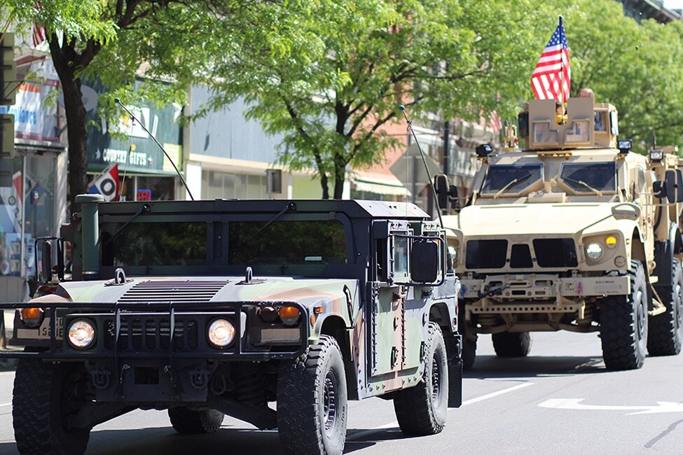    Tactical military vehicles, brought by the New York Army National Guard, travel down the parade route. (Rachel Hunter photo)  