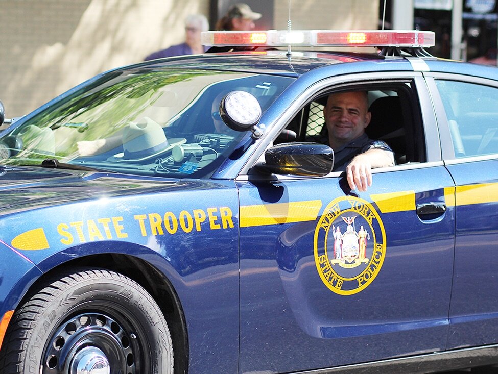    NYS Trooper Scott MacKinnon drives the NYS Trooper vehicle in the 2021 Gouverneur Memorial Day Parade on Monday, May 31. (Rachel Hunter photo)  