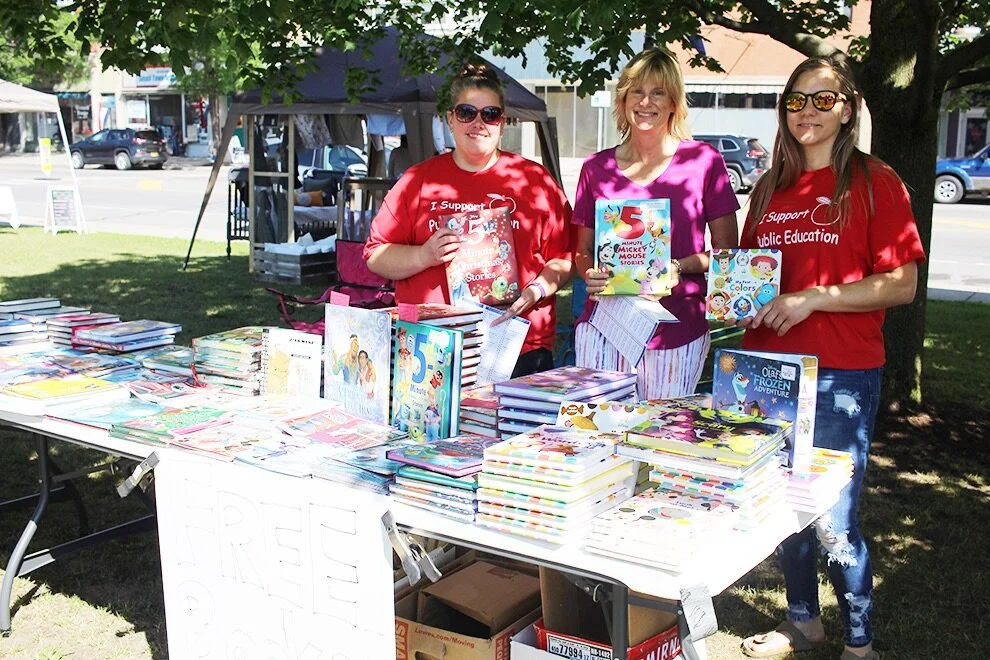    Gouverneur Teachers Association distribute free books to local residents at the 30th Annual Arts In The Park on Saturday, June 19. (Rachel Hunter photo)  