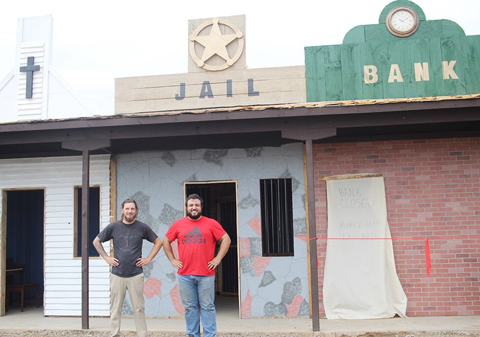    From left: Chris Dillon and Alex Bender of Harvest Town Corn Maze in Gouverneur stand in front of their newly constructed Wild West themed buildings. (Rachel Hunter photo)  