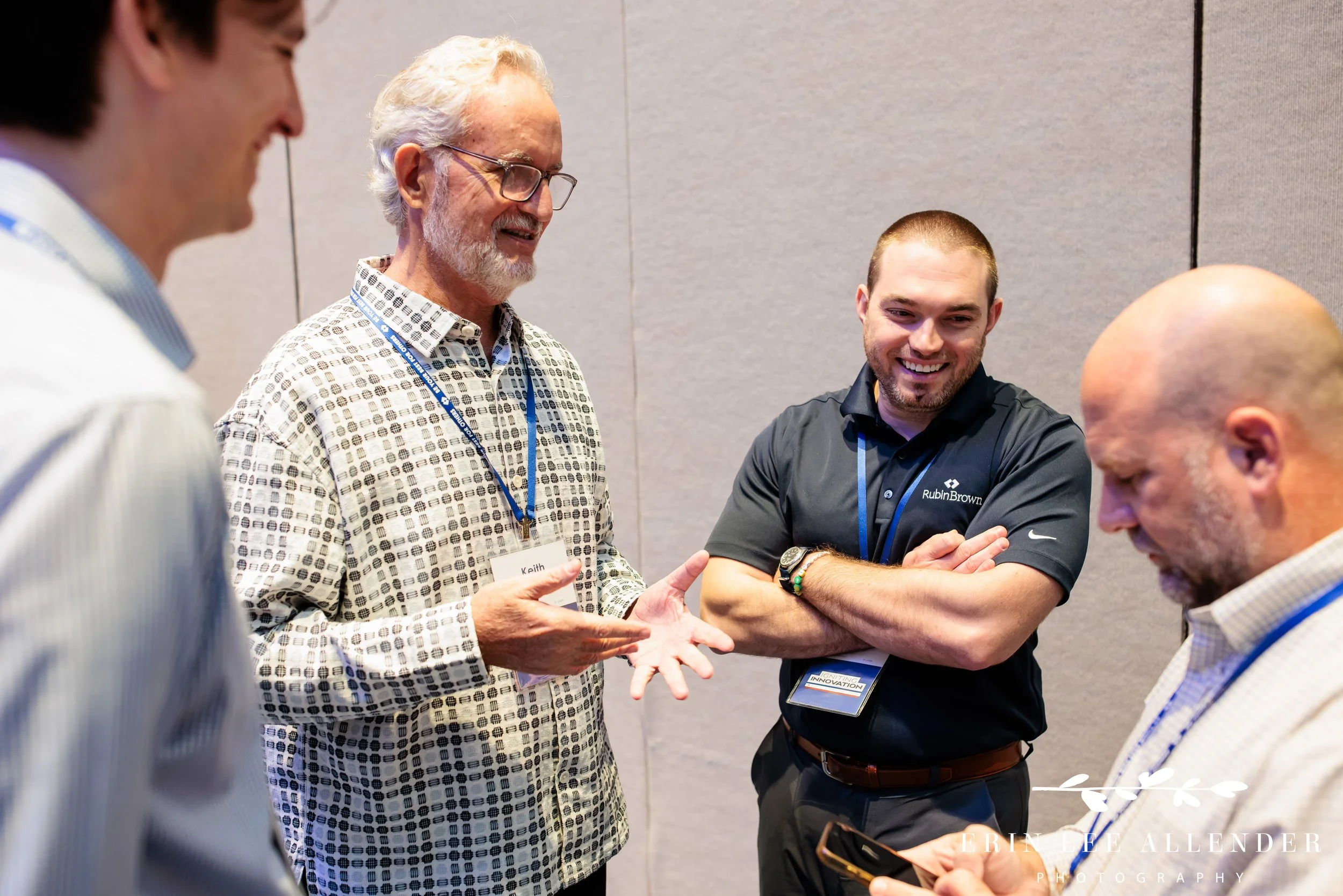 Nashville conference photographer covering colleagues standing in conversation during a breakout session at Opryland