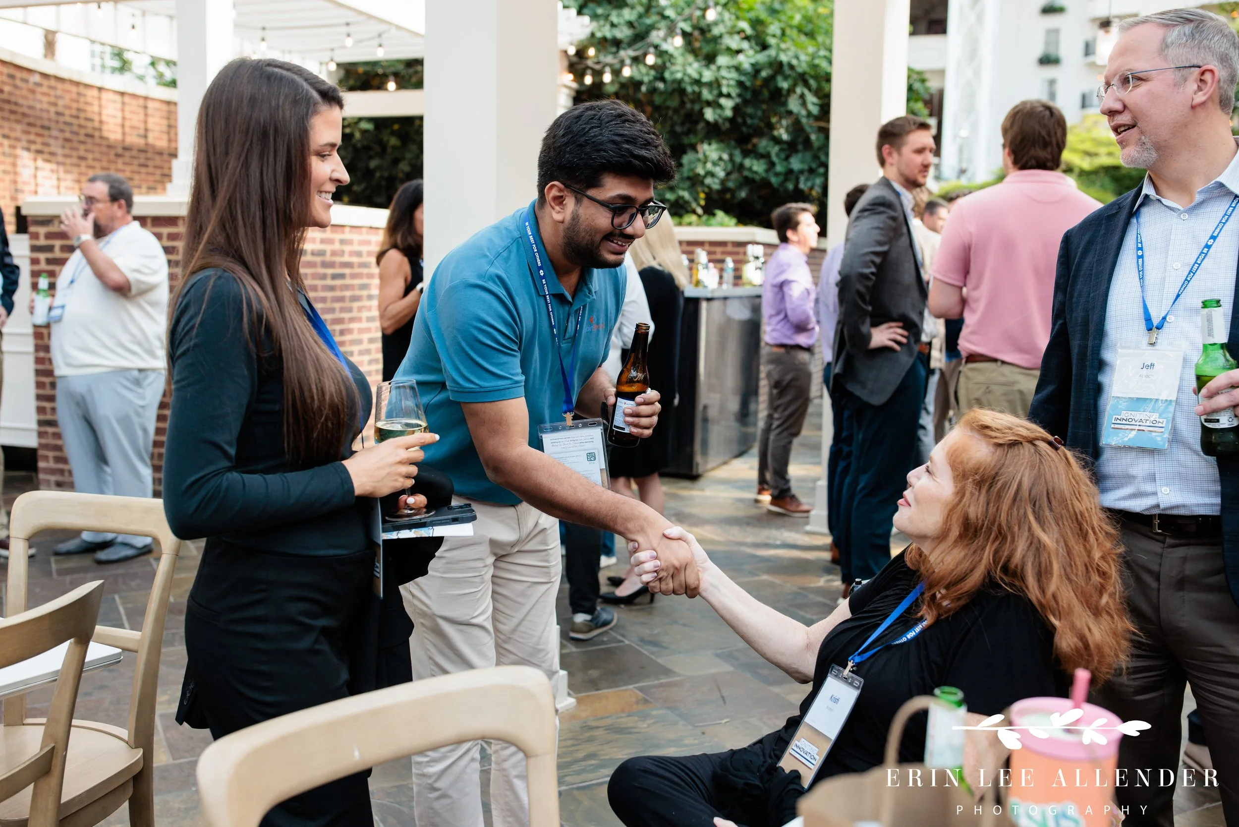 Opryland Hotel cocktail party photography of guests shaking hands during a RubinBrown reception on Delta Island