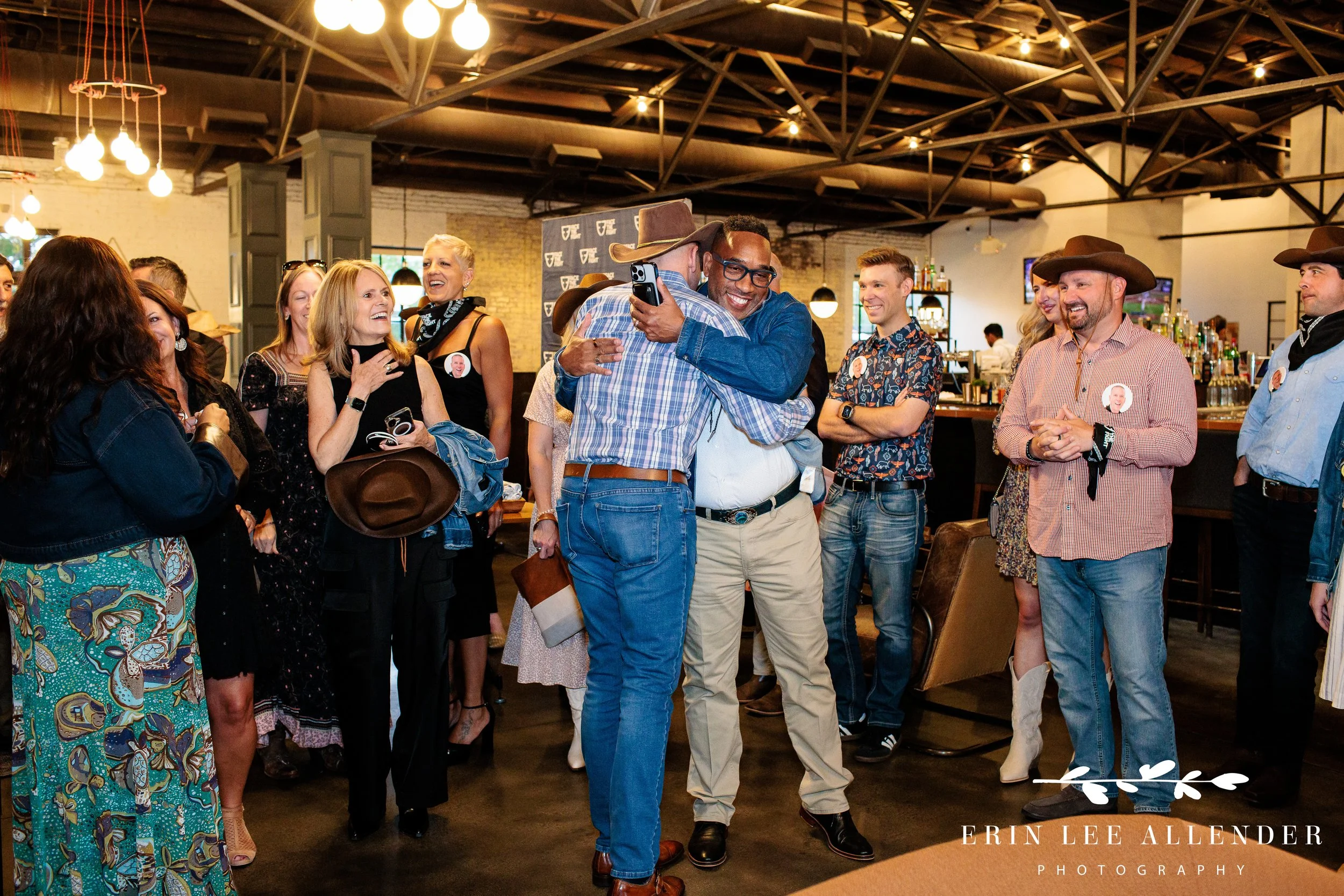Guest of honor hugging attendees during Face the Fight welcome party at Pinewood Social, Nashville