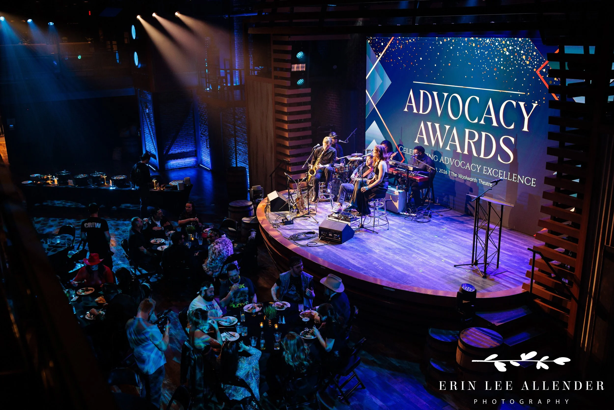 Nashville corporate event photographer — wide room shot of Moga Family Band performing live on stage at wine and spirits advocacy awards, Woolworth Theatre Nashville