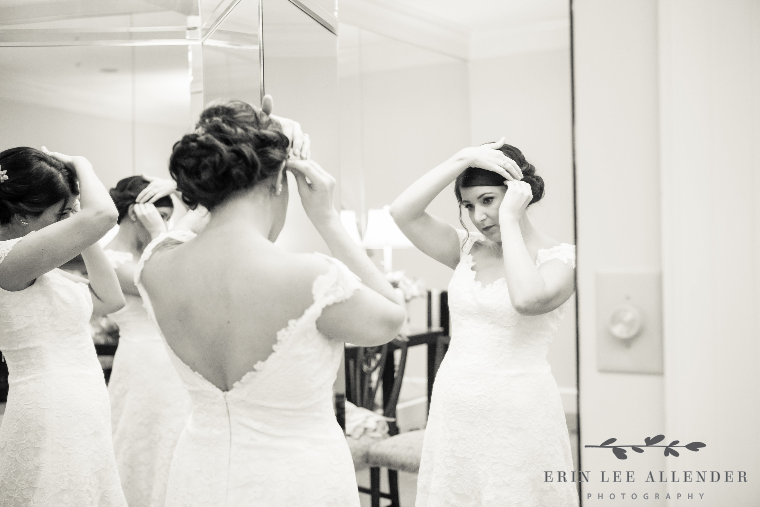 Bride_Fixing_Her_Hair_In_Mirror