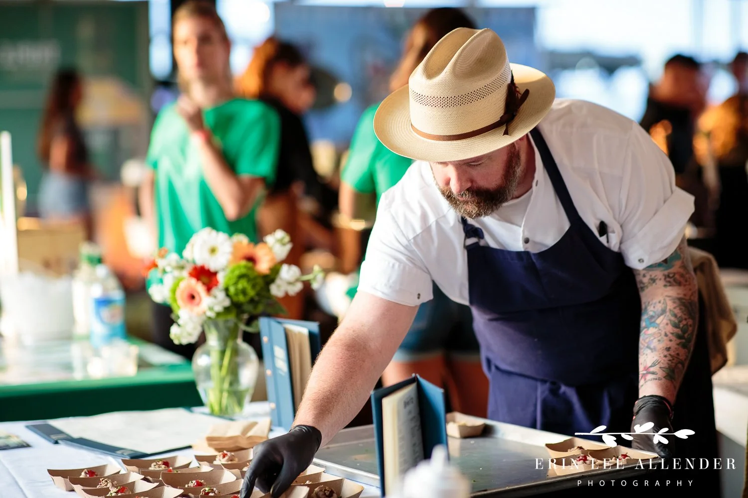 Chef plating and handing out food samples to guests at the Music City Food and Wine Festival Nashville