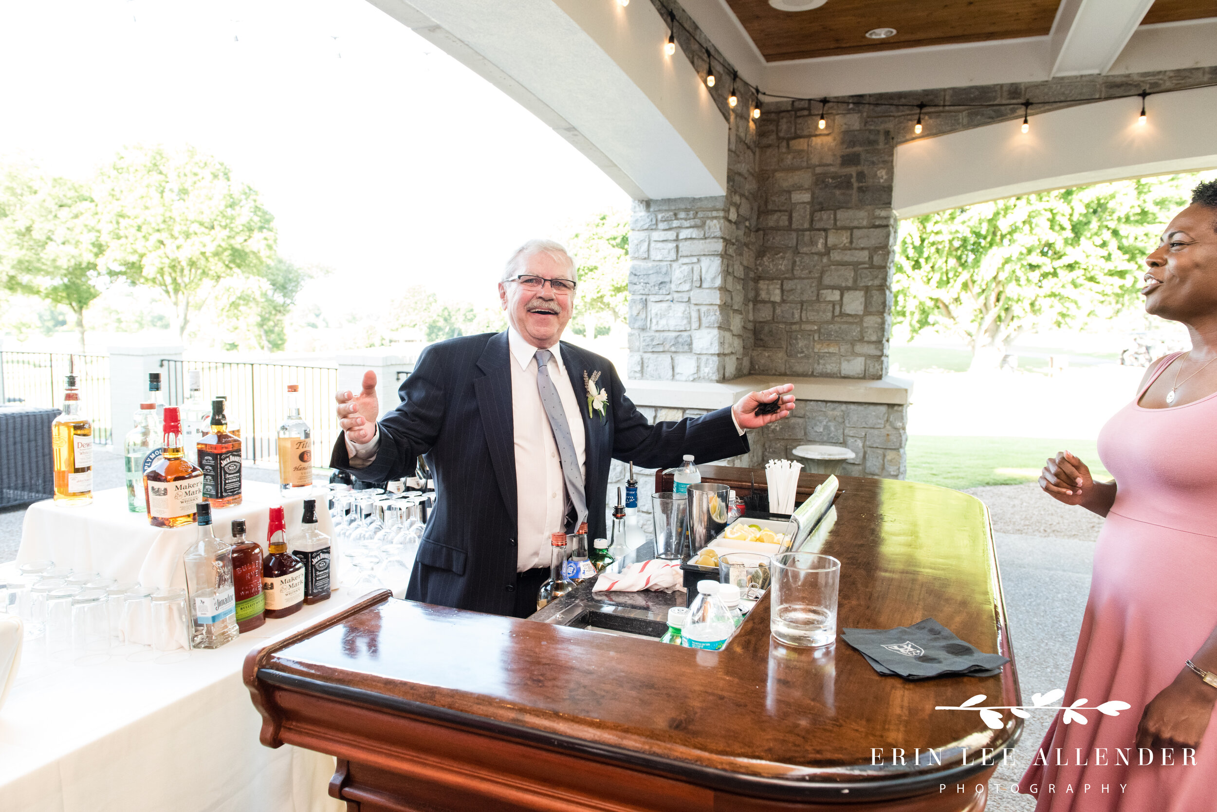 father-of-groom-behind-bar