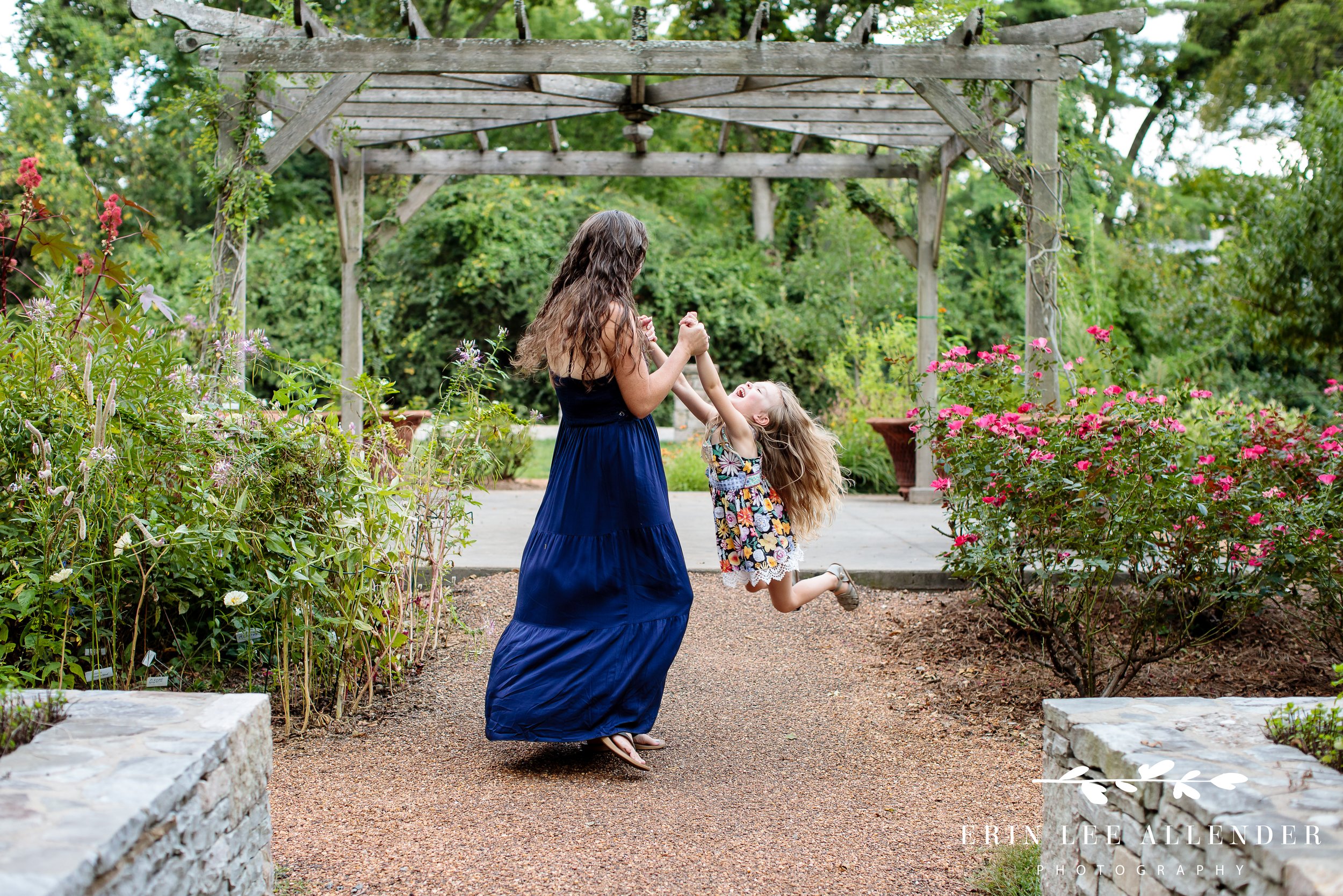 mother-swinging-little-girl