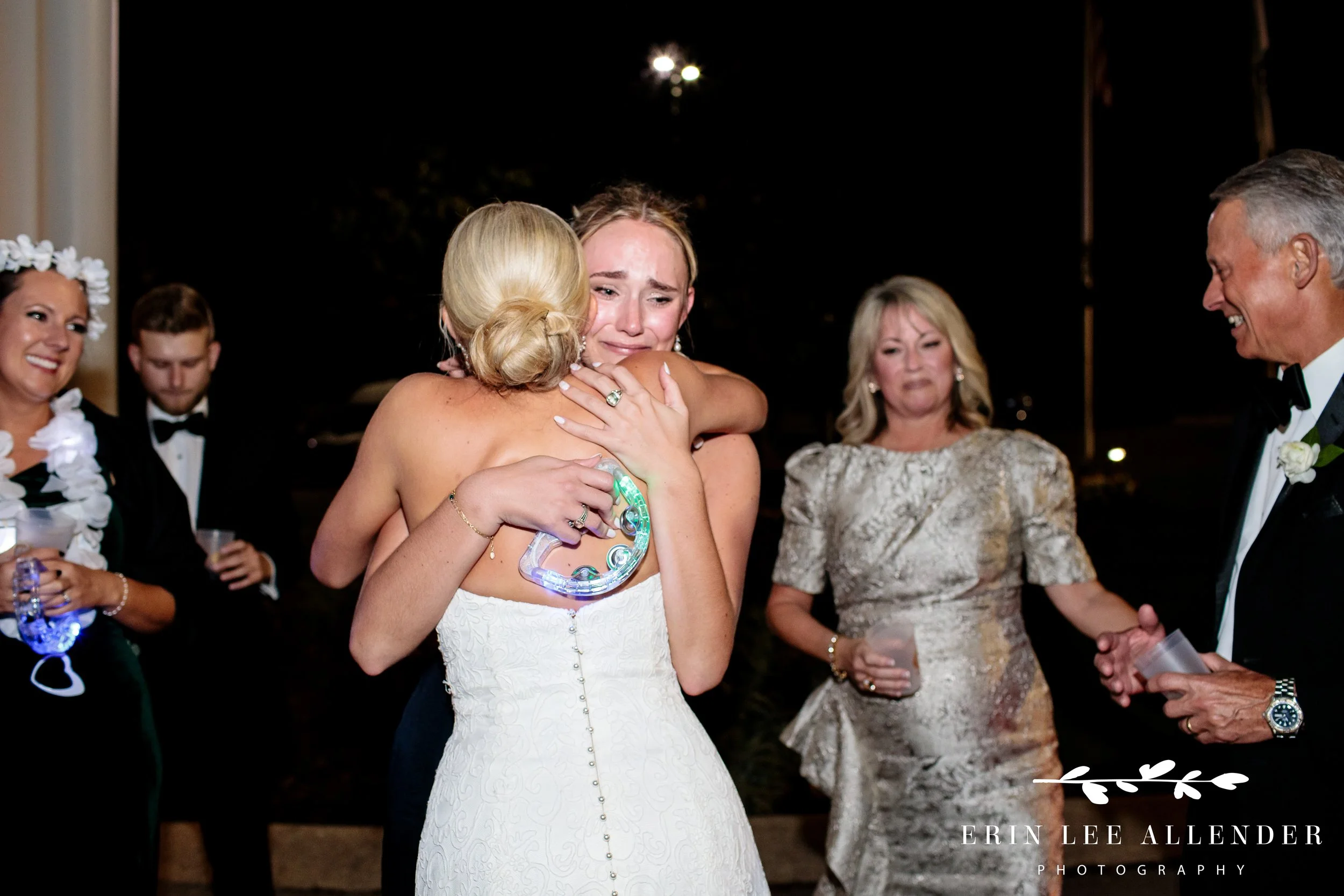 Sister crying and hugging bride during Nashville wedding celebration