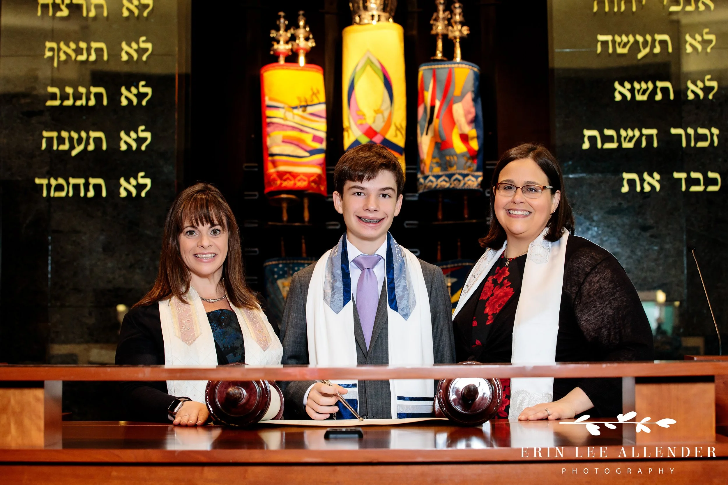 Bar Mitzvah boy holding the Torah on the bimah at The Temple Nashville