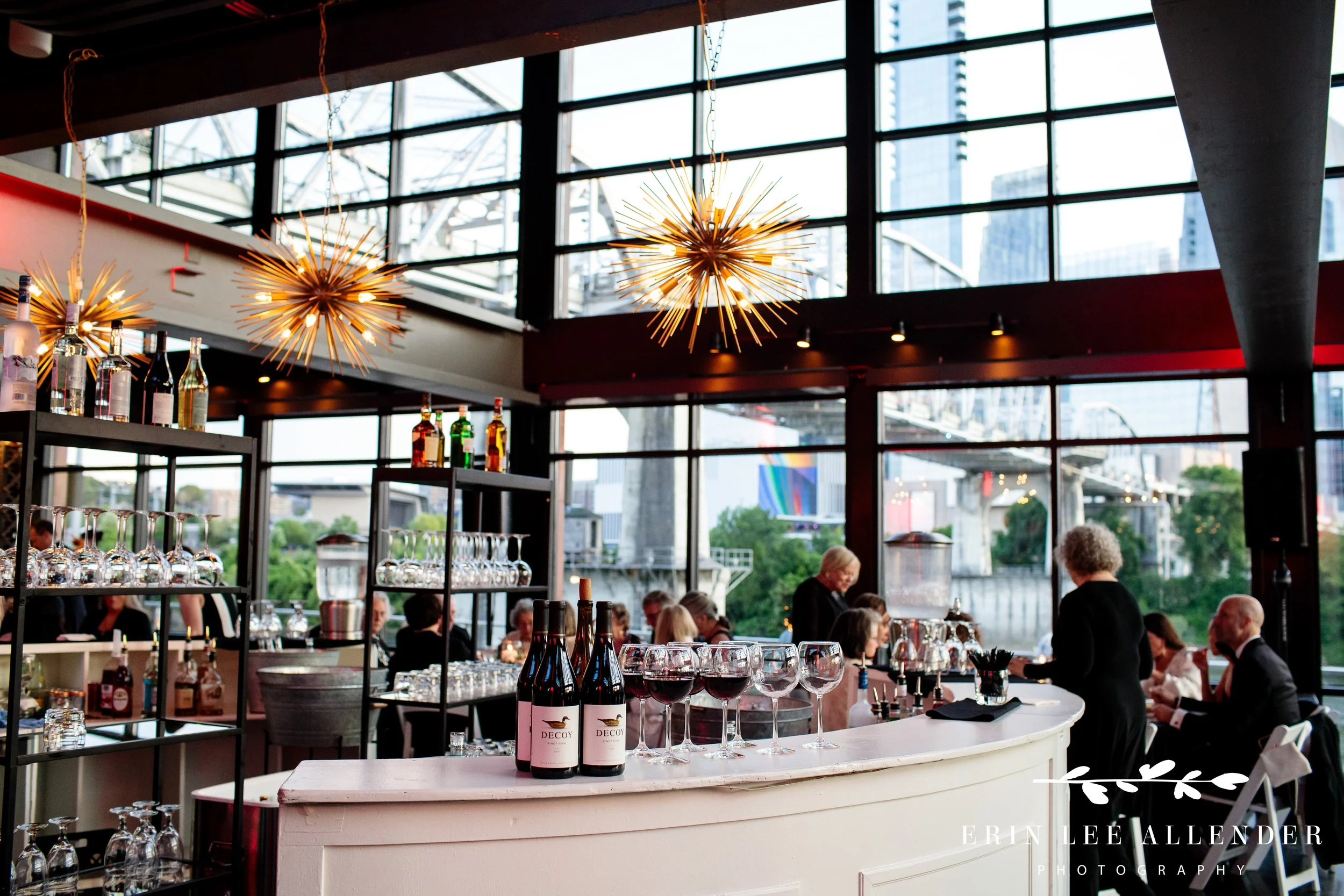 Bar setup with wine glasses and Cumberland Bridge view at The Bridge Building Nashville.