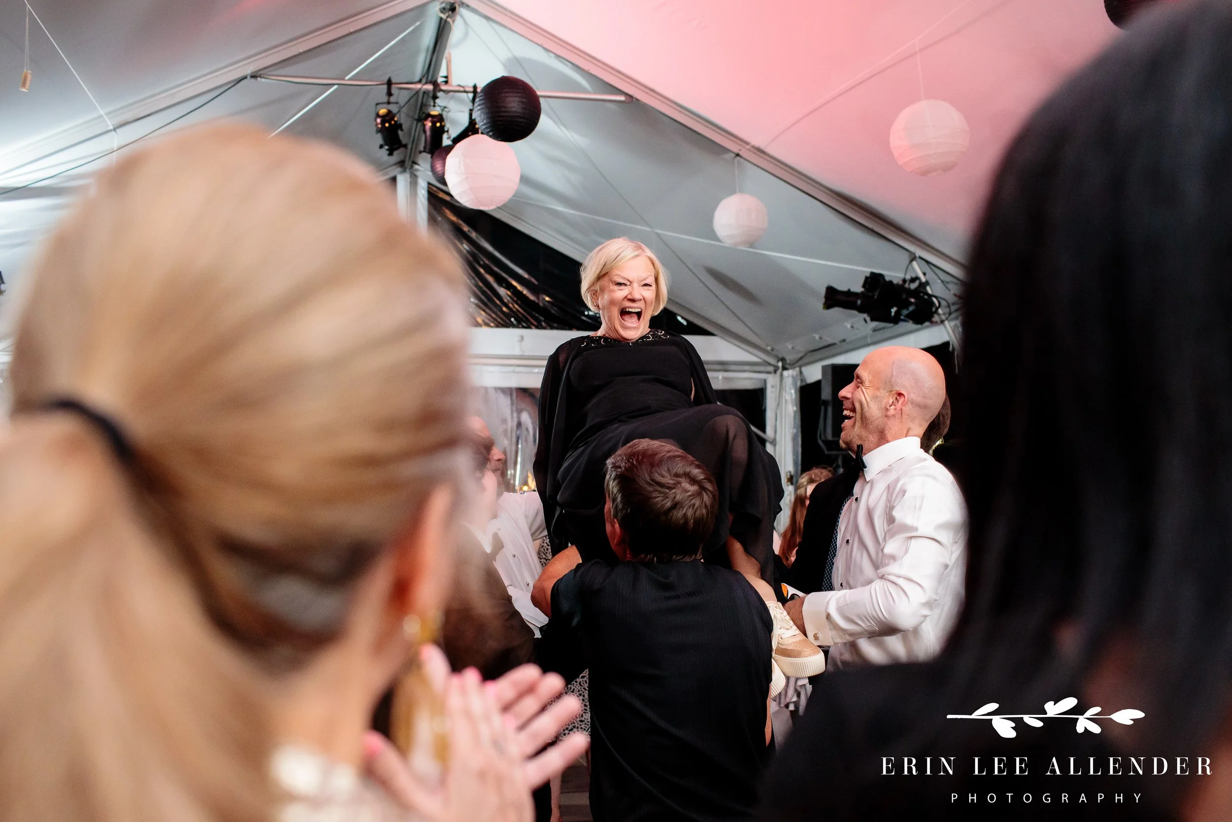 Grandmother lifted in chair during horah at The Bridge Building Nashville.