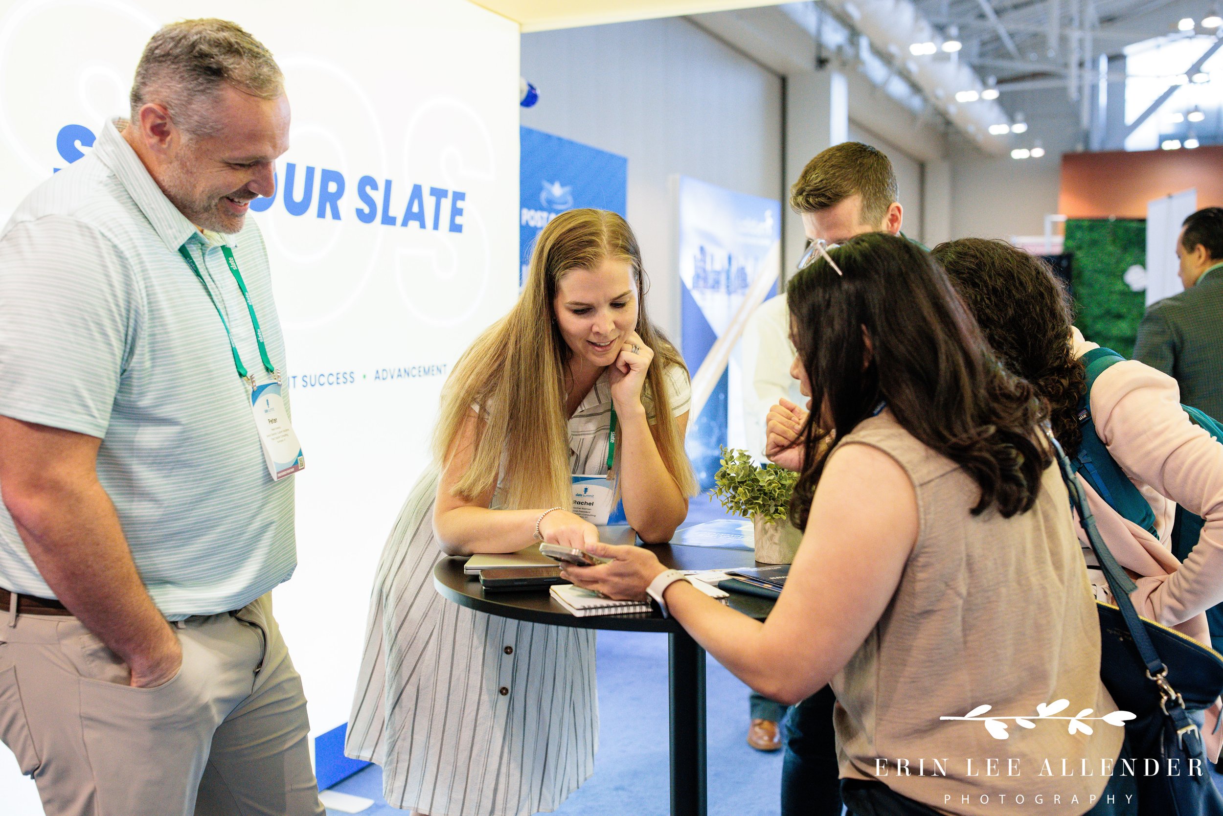 Nashville conference photographer — Post Captain consultant explaining a Slate feature to an attendee in the expo hall at the Slate Summit