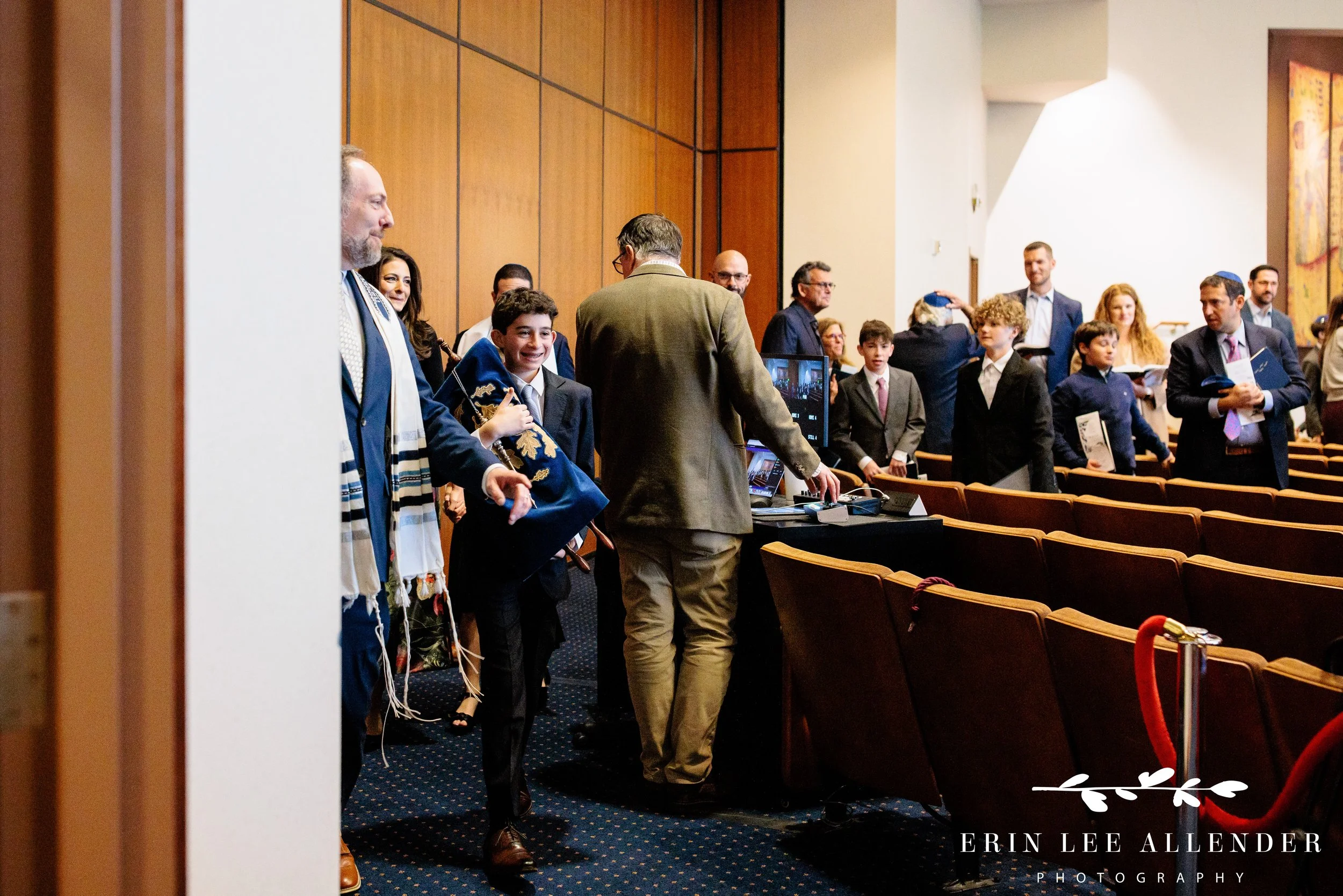 Bar mitzvah carrying Torah during processional at The Temple