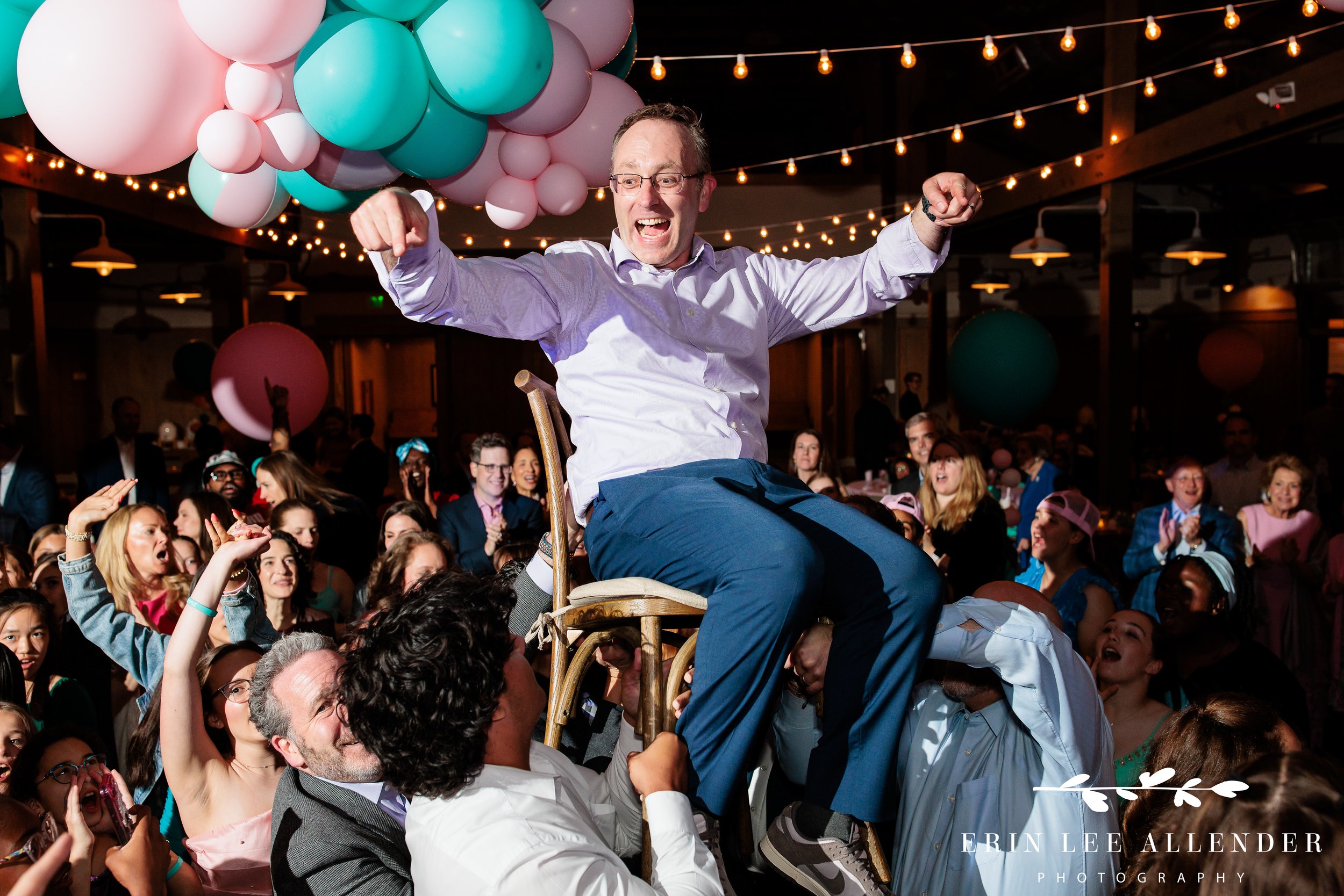 Nashville mitzvah photography — dad swinging daughter during hora at Sari's bat mitzvah Loveless Barn
