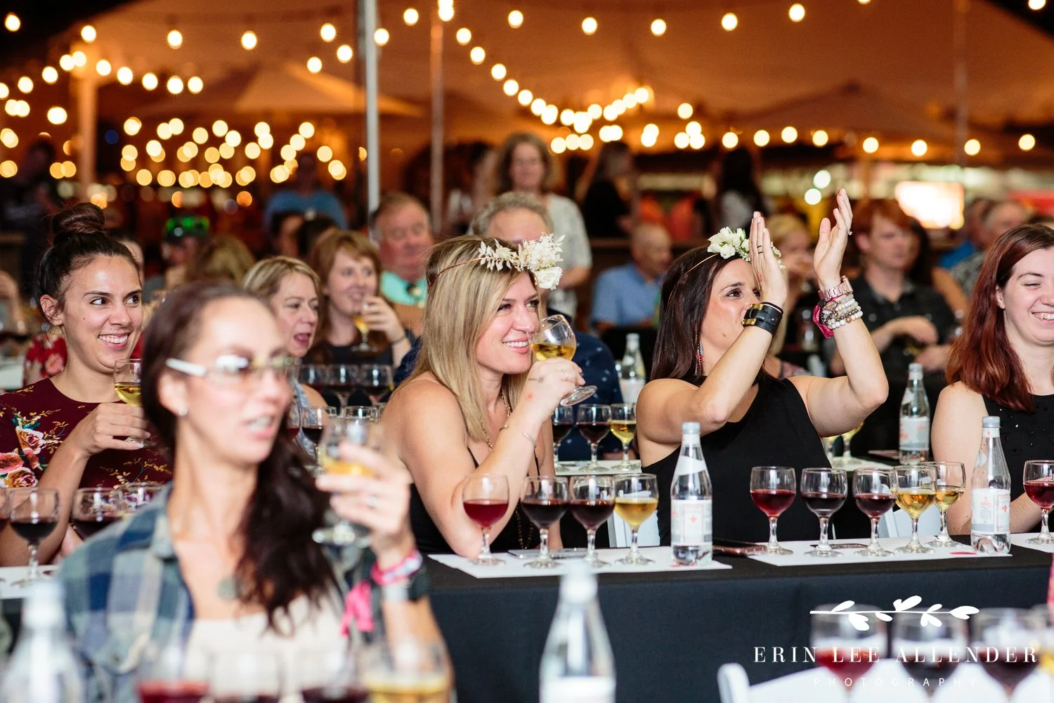 Woman clapping while tasting wine at the wine tasting event at the Music City Food and Wine Festival Nashville Tennessee