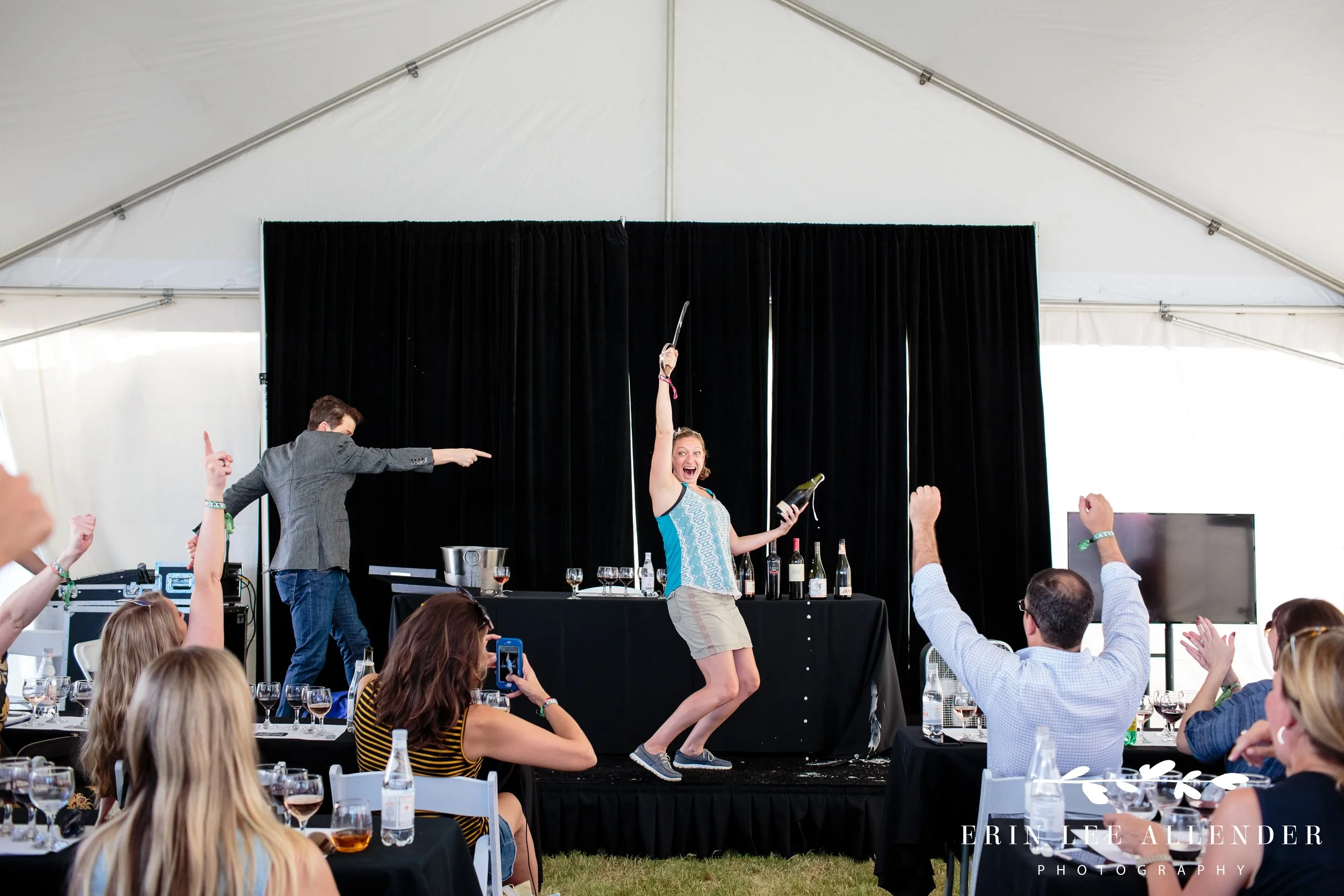 Guest sabering a champagne bottle at the sparkling wine tasting event at the Music City Food and Wine Festival Nashville Tennessee