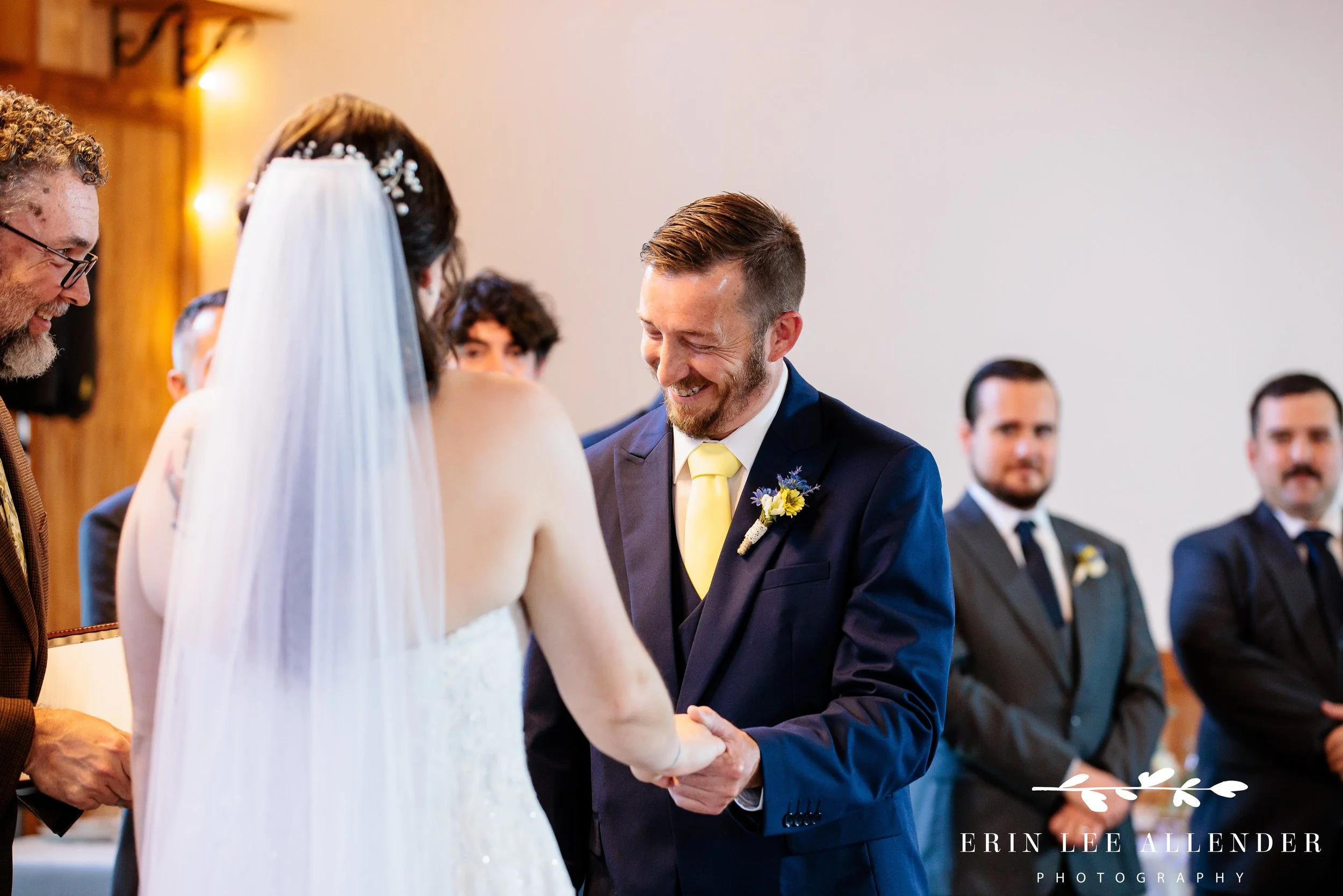 Groom laughing during vows