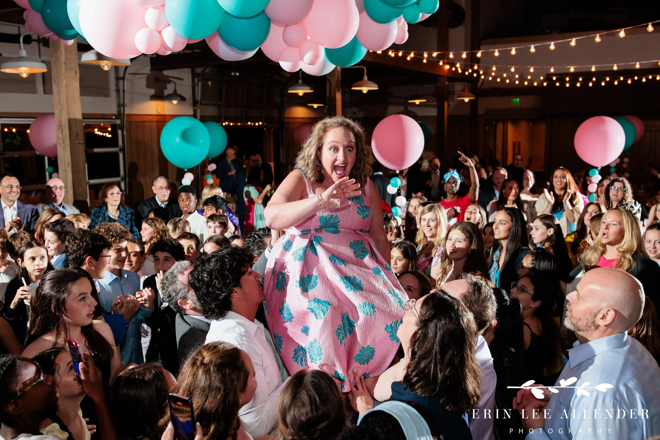 Nashville mitzvah photography — mom lifted in chair during hora at Sari's bat mitzvah Loveless Barn