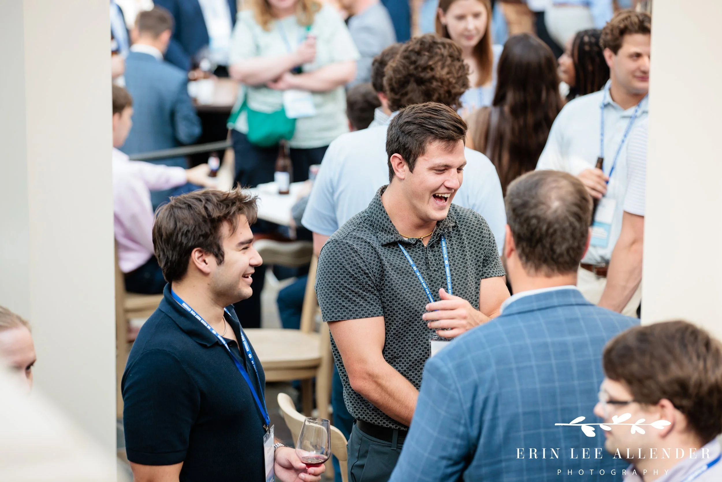 Opryland Hotel cocktail party photography of a group of men laughing together during a RubinBrown reception on Delta Island